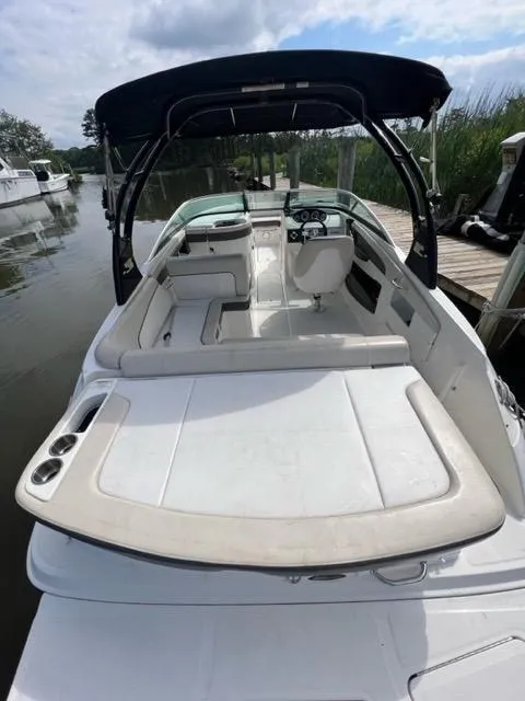 Slide: The Image of 2013 Sea Ray 240 Sundeck boat with spacious seating and sleek design. - 11