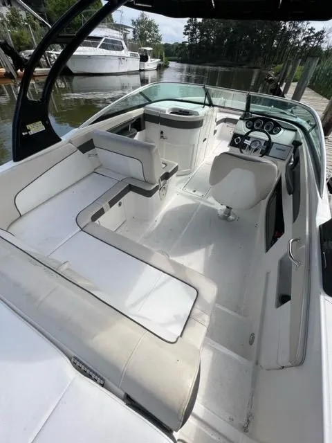 Slide: The Image of 2013 Sea Ray 240 Sundeck boat interior with seating and control panel. - 12
