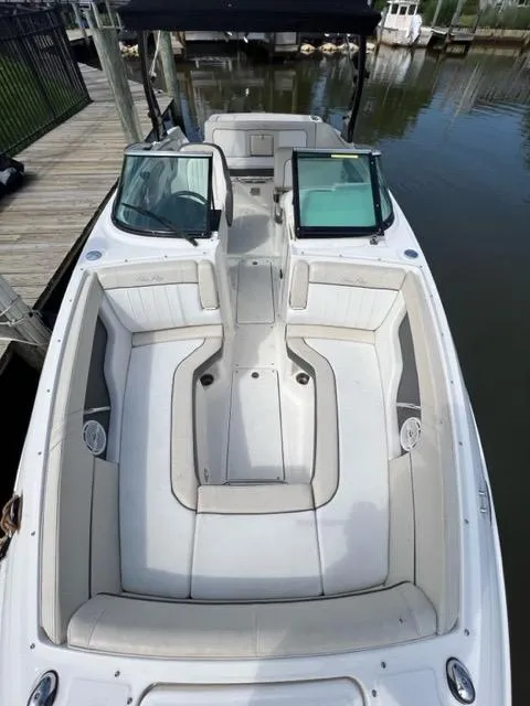 Slide: The Image of 2013 Sea Ray 240 Sundeck boat with spacious seating and sleek design. - 14