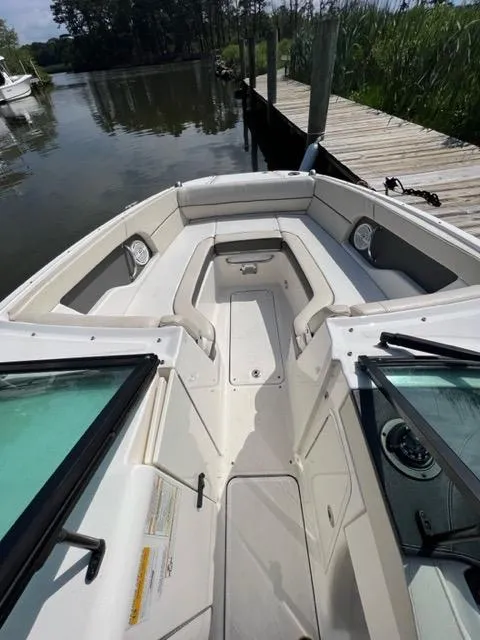 Slide: The Image of 2013 Sea Ray 240 Sundeck boat interior at dock, spacious seating and clean design. - 15