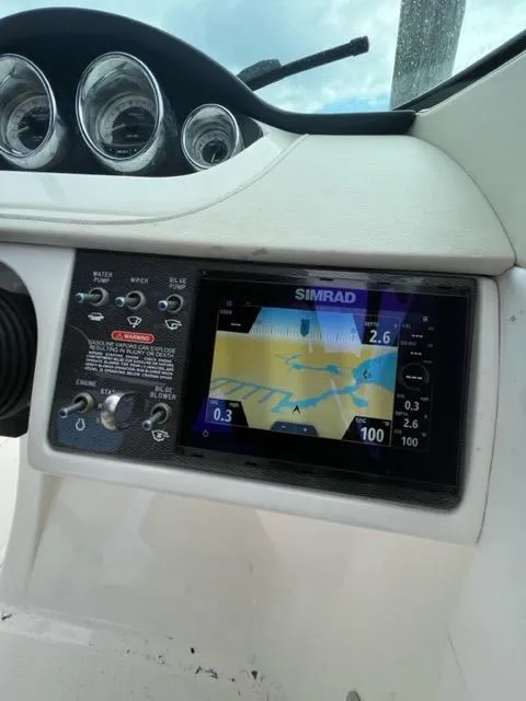 Slide: The Image of 2013 Sea Ray 240 Sundeck dashboard with Simrad navigation system. - 19