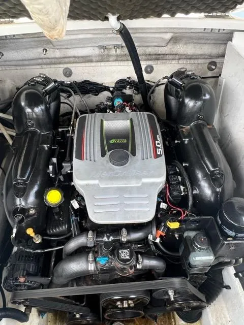 Slide: The Image of 2013 Sea Ray 240 Sundeck engine compartment with a powerful 5.0L motor. - 22