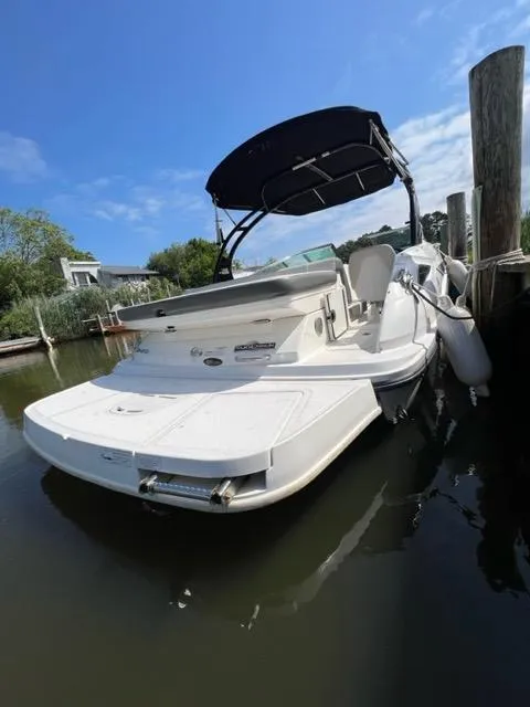 Slide: The Image of 2013 Sea Ray 240 Sundeck boat docked in calm waters. - 3