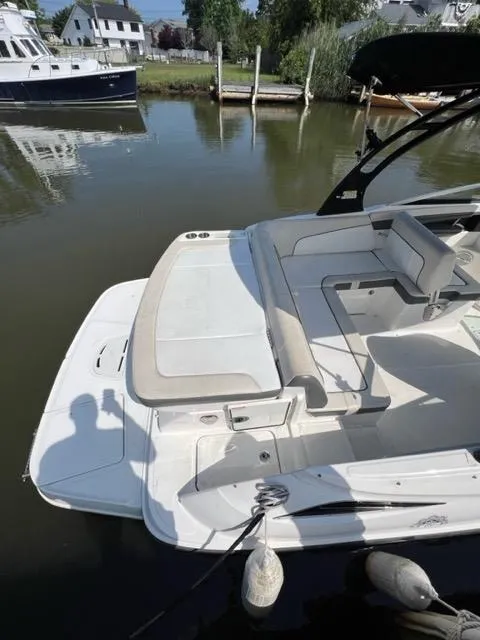 Slide: The Image of 2013 Sea Ray 240 Sundeck boat docked in a calm marina. - 4
