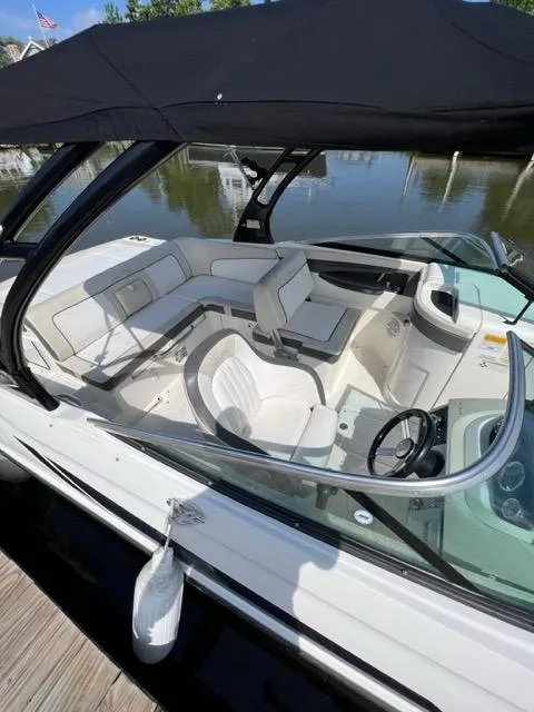 Slide: The Image of 2013 Sea Ray 240 Sundeck boat with spacious seating and black canopy. - 5