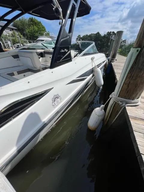 Slide: The Image of 2013 Sea Ray 240 Sundeck docked, side view with fenders. - 7