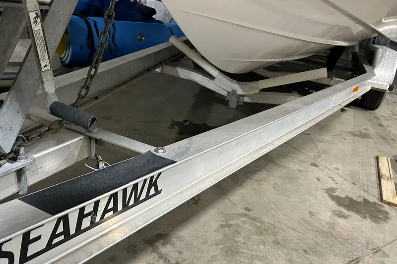 Slide: The Image of 2008 Four Winns 262 boat on a Seahawk trailer in a garage. - 15