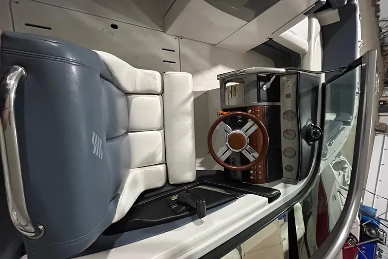 Slide: The Image of 2008 Four Winns 262 boat cockpit with steering wheel and seating. - 11