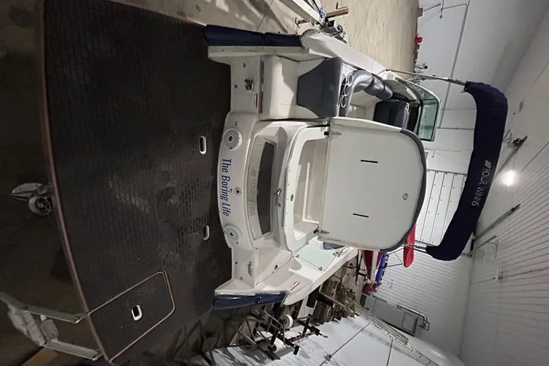 Slide: The Image of 2008 Four Winns 262 boat in storage, rear view with swim platform and seating. - 13