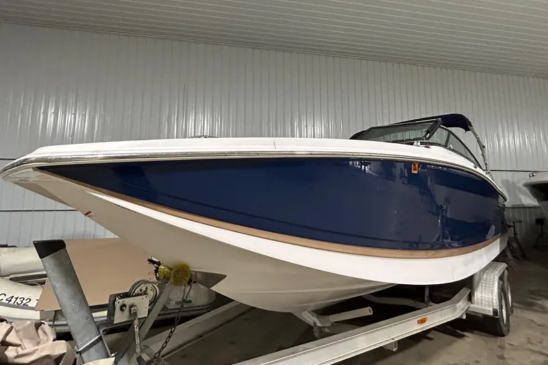 Slide: The Image of 2008 Four Winns 262 boat on a trailer in a storage facility. - 14