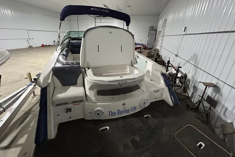 Slide: The Image of 2008 Four Winns 262 boat in indoor storage with open engine compartment. - 6