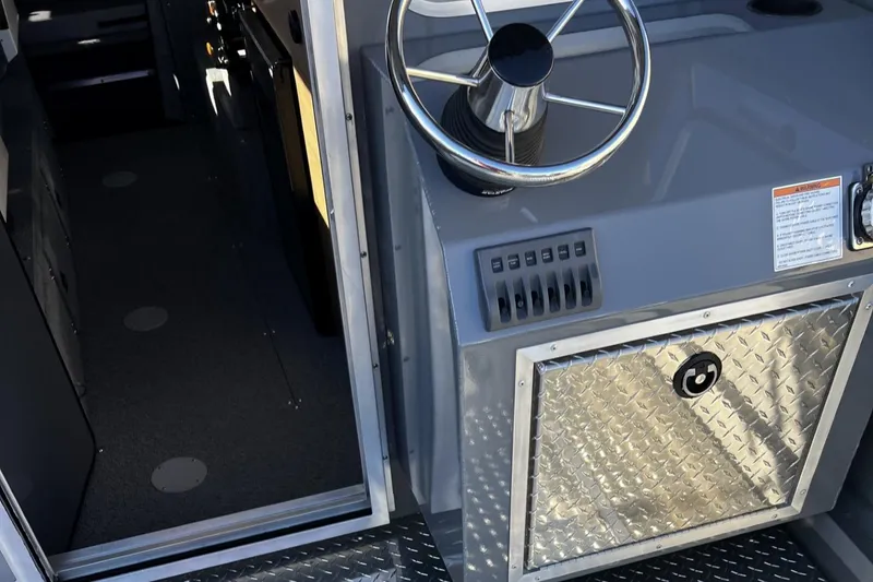 Slide: The Image of 2023 Thunder Jet 26 Pilot boat interior with steering wheel and control panel. - 15