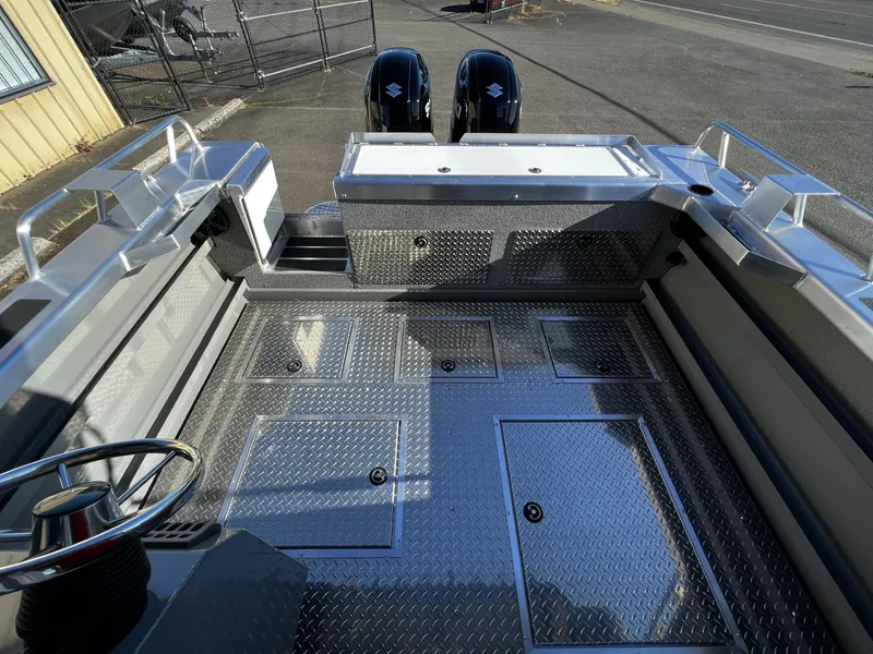 Slide: The Image of 2023 Thunder Jet 26 Pilot boat interior with diamond plate flooring and dual outboard motors. - 16