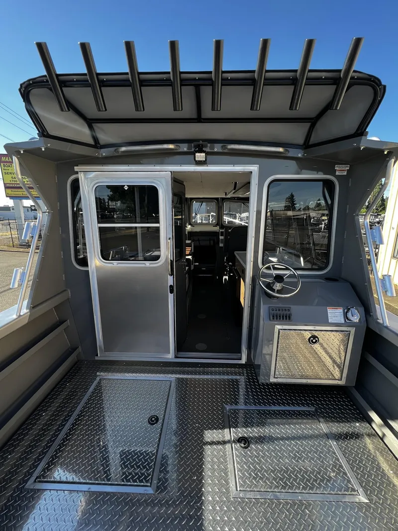 Slide: The Image of 2023 Thunder Jet 26 Pilot boat interior with steering wheel and storage compartments. - 17