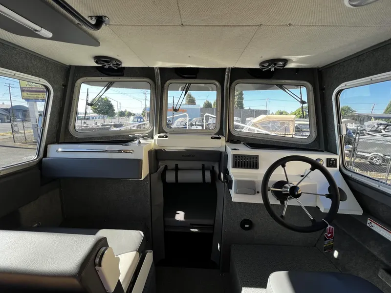 Slide: The Image of 2023 Thunder Jet 26 Pilot boat interior with steering wheel and panoramic windows. - 4
