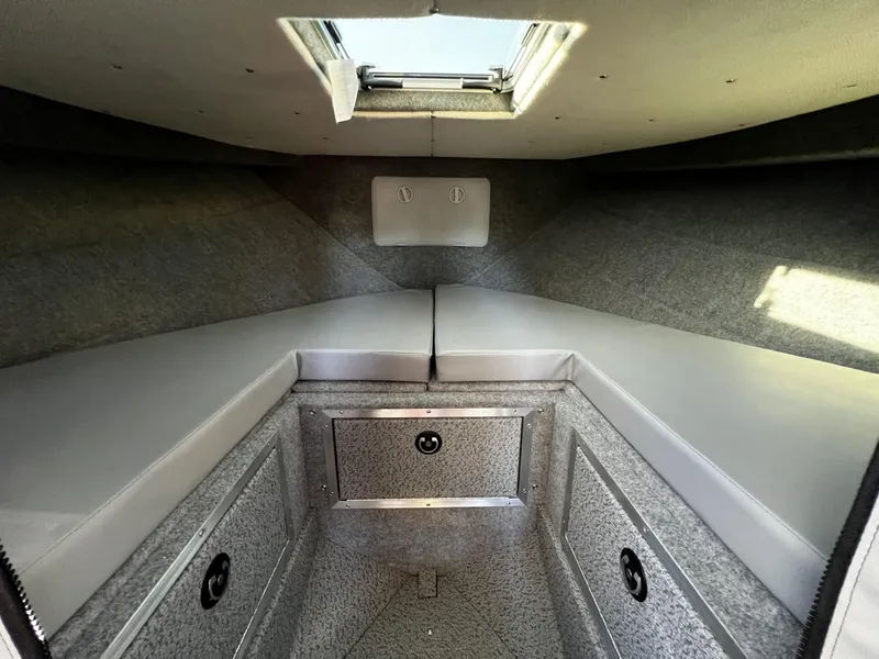 Slide: The Image of Interior cabin of 2023 Thunder Jet 26 Pilot boat with cushioned seating and storage. - 5