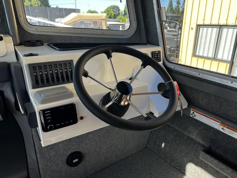 Slide: The Image of 2023 Thunder Jet 26 Pilot boat cockpit with steering wheel and control panel. - 7