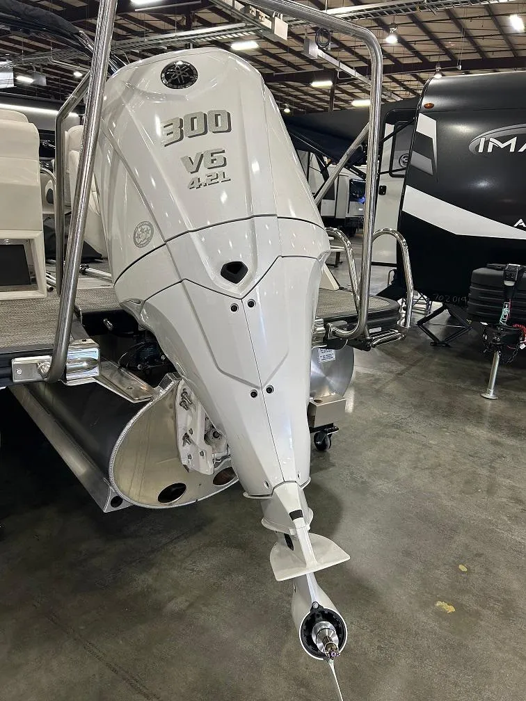 Slide: The Image of 2024 Bennington 23 RFBA boat with powerful 300 V6 engine displayed indoors. - 19