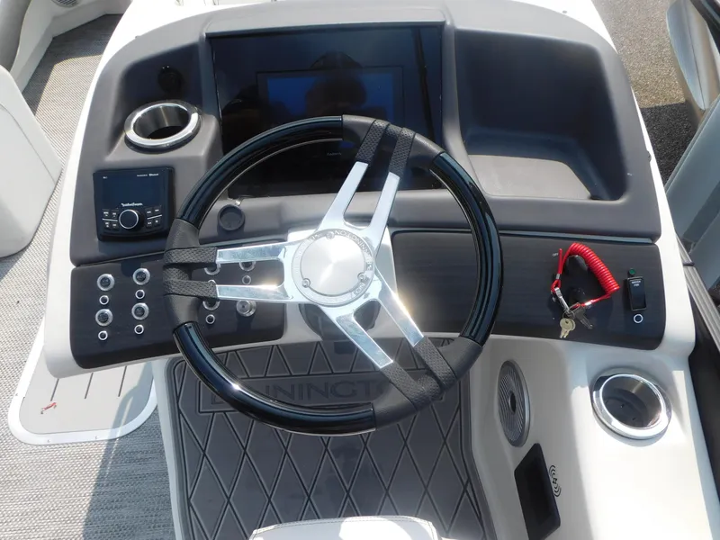 Slide: The Image of 2024 Bennington 23 RFBA boat steering console with modern controls and key ignition. - 3