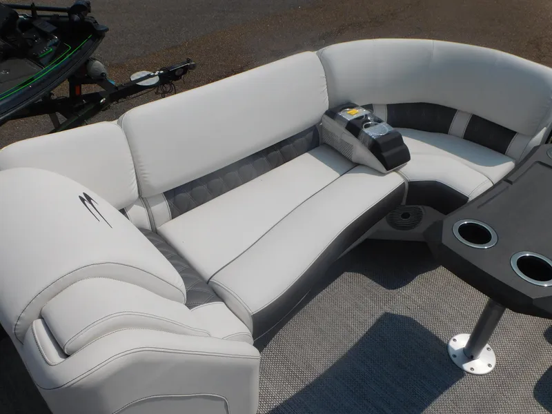 Slide: The Image of 2024 Bennington 23 RFBA boat interior with plush seating and cup holders. - 5