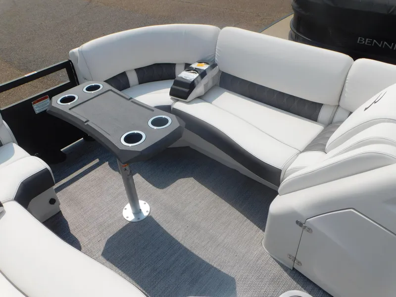 Slide: The Image of 2024 Bennington 23 RFBA boat interior with white and gray seating and cup holders. - 6