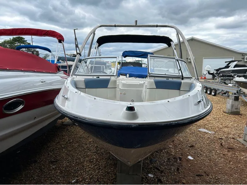 Slide: The Image of 2013 Bayliner 185 boat on display at a marina. - 12