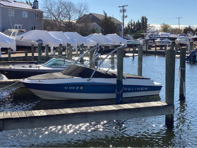 Slide: The Image of 2013 Bayliner 185 boat docked at a marina on a sunny day. - 13