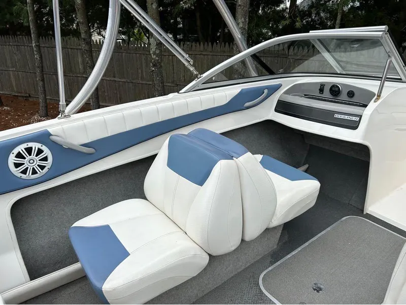 Slide: The Image of 2013 Bayliner 185 boat interior with blue and white seats and dashboard. - 3