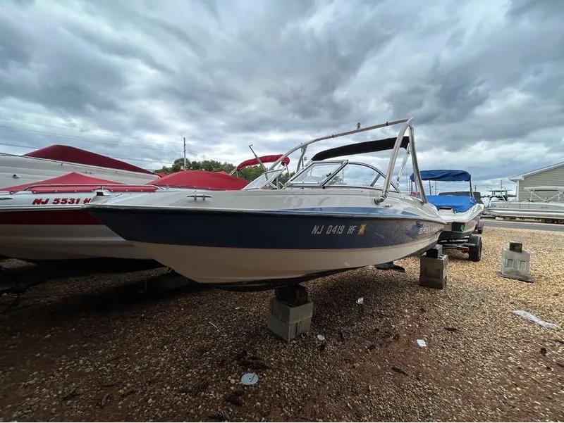 Slide: The Image of 2013 Bayliner 185 boat on blocks, cloudy sky background. - 7