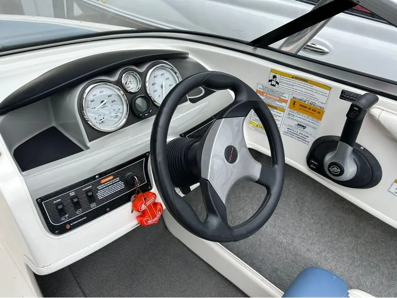 Slide: The Image of 2013 Bayliner 185 boat dashboard with steering wheel, gauges, and control panel. - 8