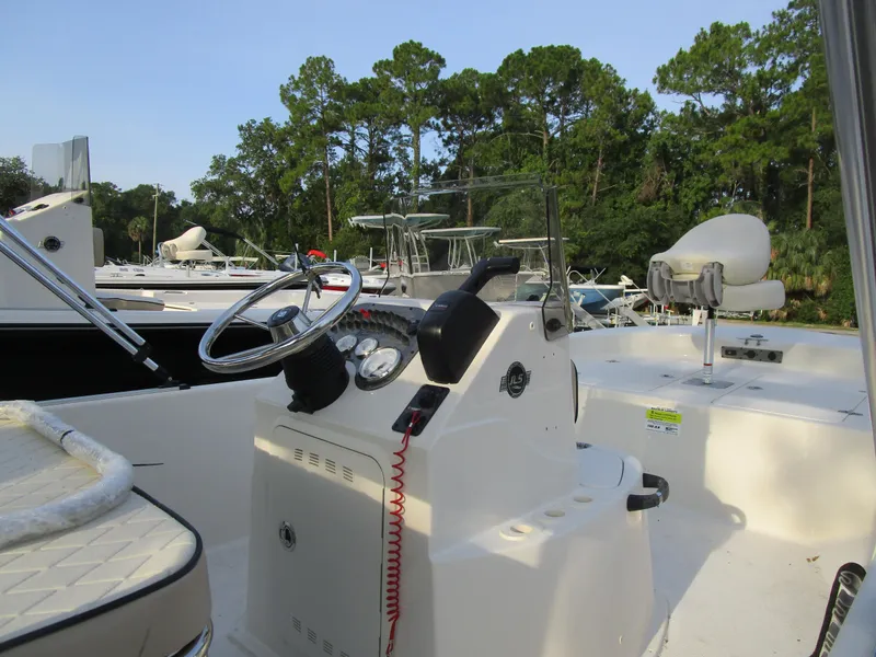Slide: The Image of 2024 Carolina Skiff 192 JLS boat interior with steering wheel and seating. - 3