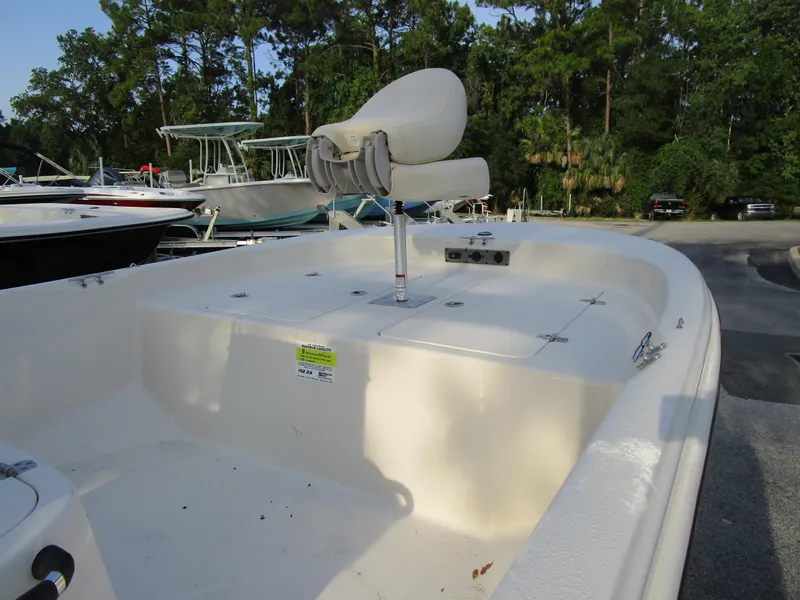 Slide: The Image of 2024 Carolina Skiff 192 JLS boat interior with seating and storage compartments. - 4