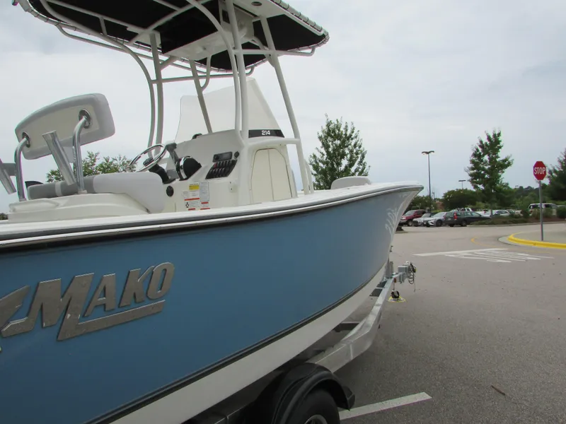 Slide: The Image of 2023 Mako 214 CC boat in a parking lot. - 10