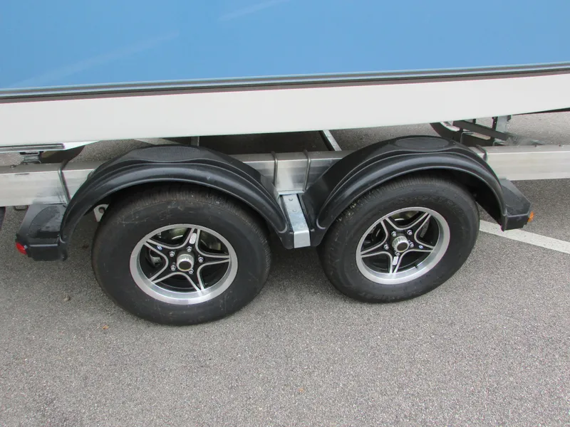 Slide: The Image of 2023 Mako 214 CC boat trailer with dual axle wheels. - 12