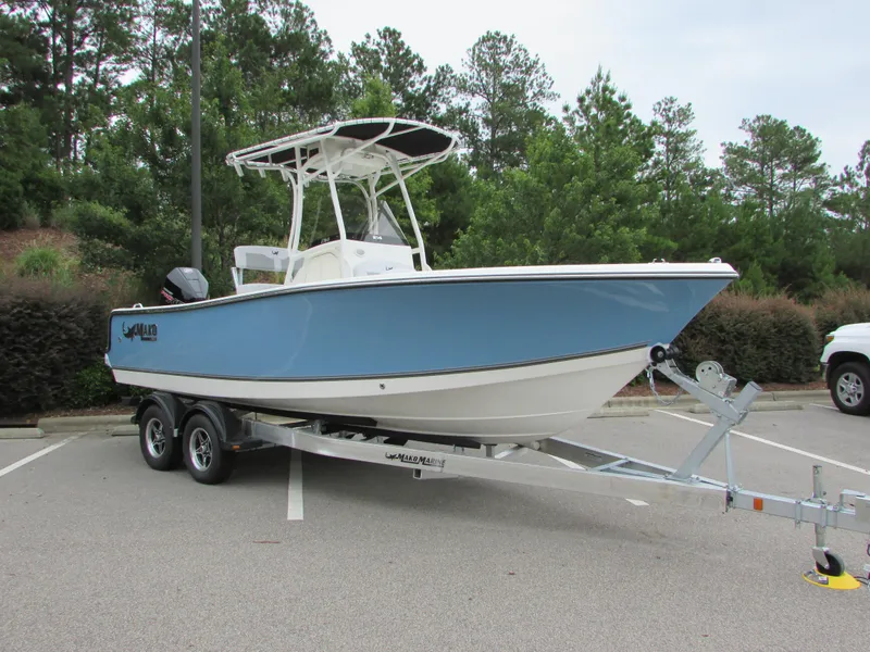 Slide: The Image of 2023 Mako 214 CC boat on a trailer in a parking lot. - 4