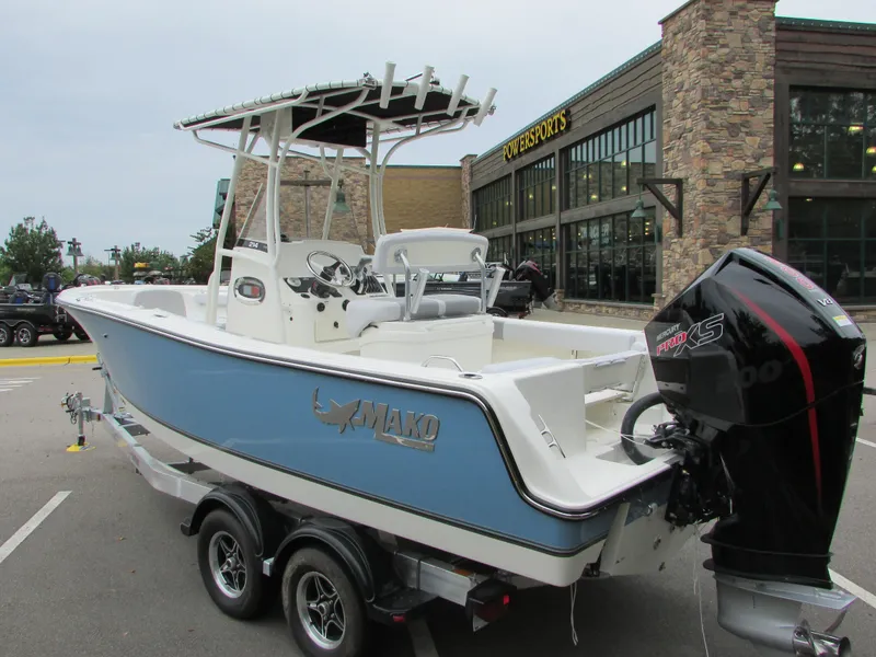 Slide: The Image of 2023 Mako 214 CC boat on a trailer outside a sporting goods store. - 5