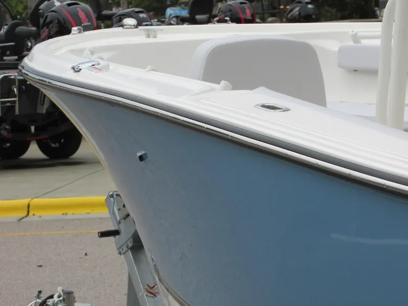 Slide: The Image of 2023 Mako 214 CC boat on trailer, close-up of bow and deck. - 8