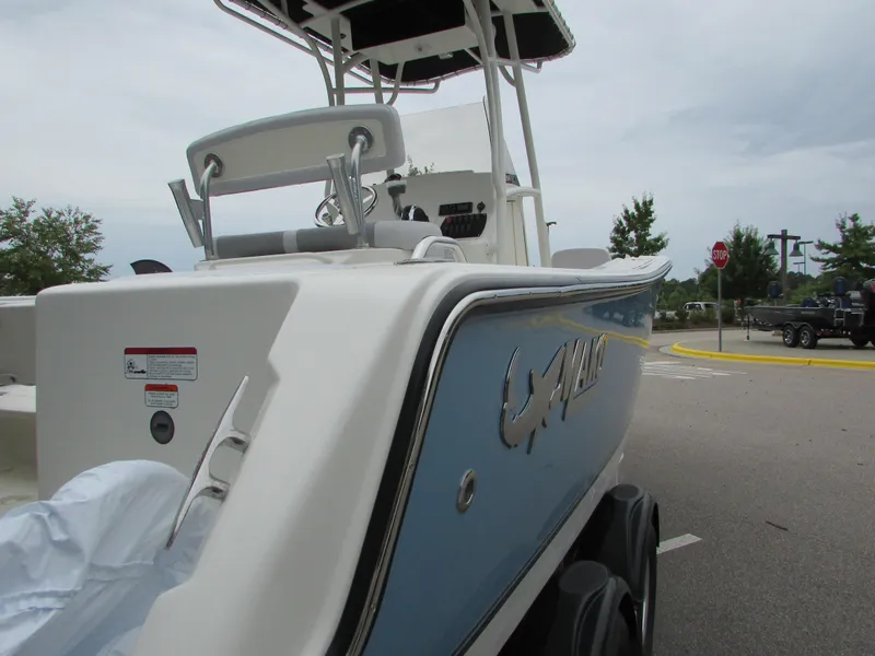 Slide: The Image of 2023 Mako 214 CC boat, side view, parked on a trailer. - 9