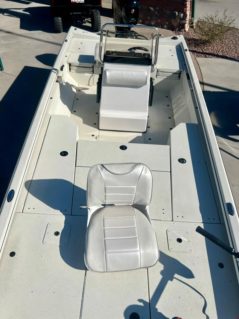 Slide: The Image of 2023 Ranger RB200 boat interior with white seating and steering console. - 2