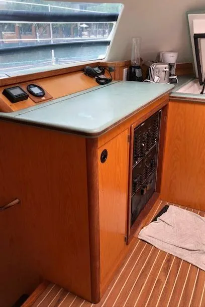 Slide: The Image of 2005 Manta 42 MK II yacht interior with wooden cabinetry and modern appliances. - 10