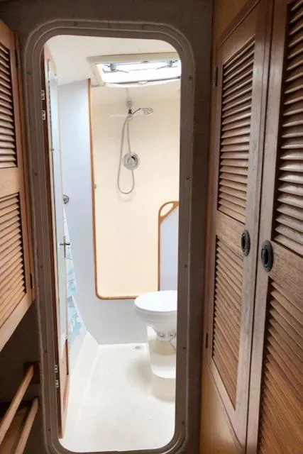 Slide: The Image of 2005 Manta 42 MK II yacht bathroom with shower, toilet, and wooden cabinets. - 13