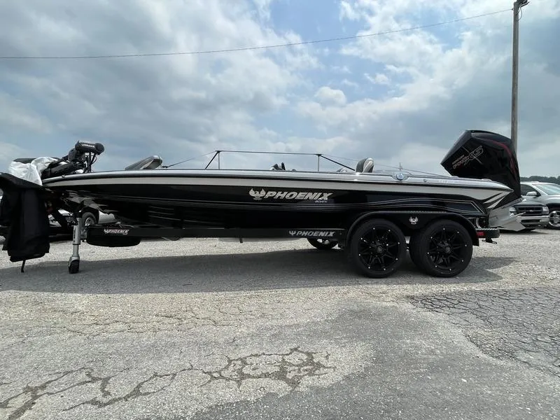 The Image of 2024 Phoenix 921 ELITE boat on a trailer, black exterior, parked outdoors. - 1