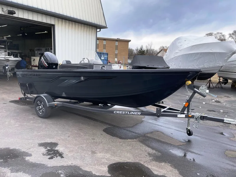 The Image of 2023 Crestliner 1650 Fish Hawk boat on a trailer outside a storage facility. - 0