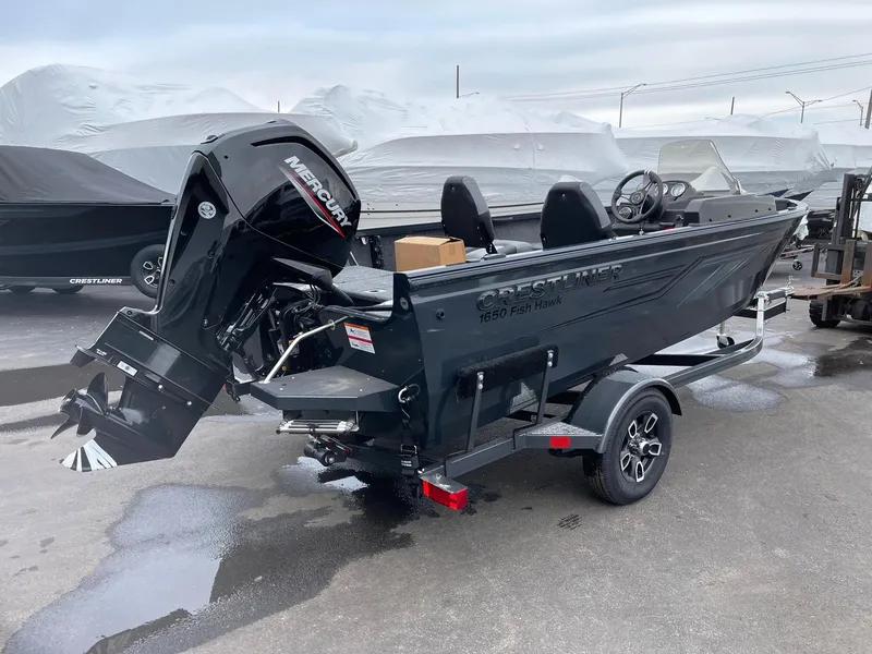 Slide: The Image of 2023 Crestliner 1650 Fish Hawk boat with Mercury outboard motor on trailer. - 1