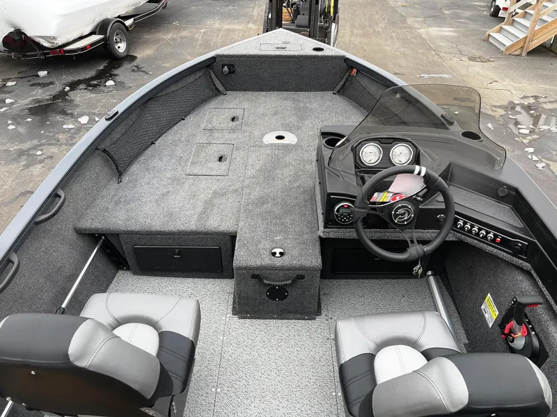 Slide: The Image of 2023 Crestliner 1650 Fish Hawk boat interior with steering console and seating. - 2