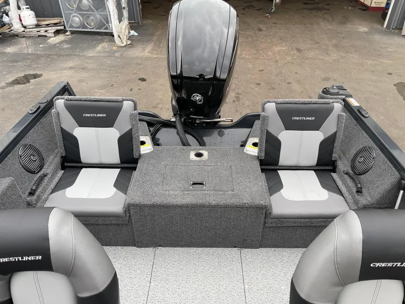 Slide: The Image of 2023 Crestliner 1650 Fish Hawk boat interior with seating and motor. - 4