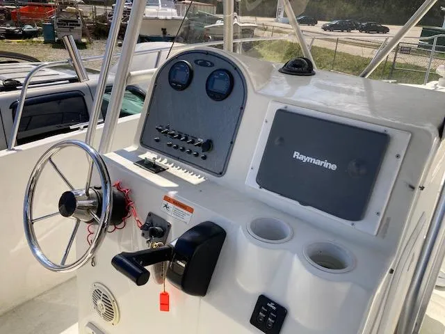Slide: The Image of 2007 Hydra-Sports 2400 boat dashboard with steering wheel and Raymarine navigation system. - 3