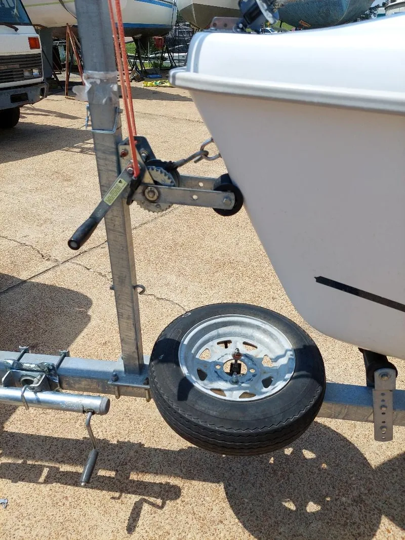 Slide: The Image of Trailer hitch and wheel of a 1998 Hunter 170 boat. - 14
