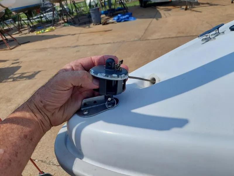 Slide: The Image of Hand holding a boat fitting on a 1998 Hunter 170 sailboat deck. - 7