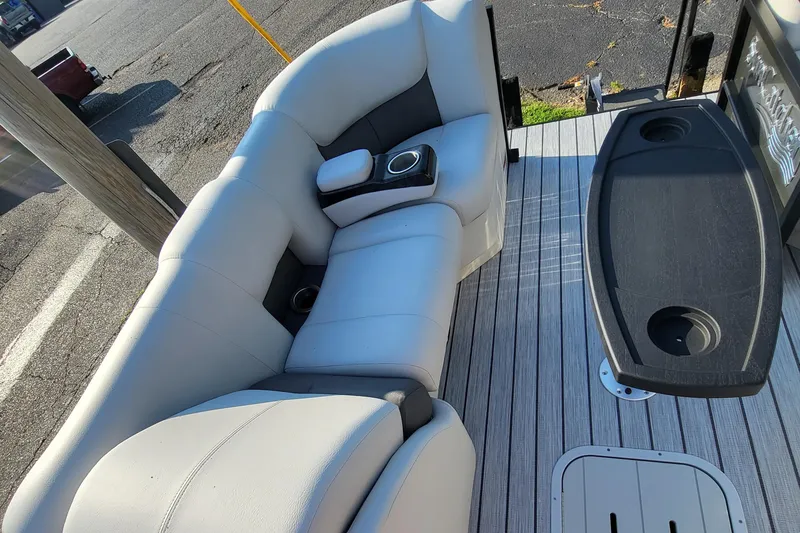 Slide: The Image of 2023 SunCatcher Fusion 322RC boat interior with cushioned seating and cup holders. - 13